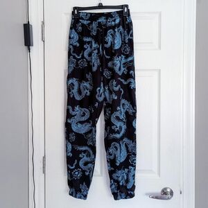 Black and teal dragon design joggers, size M